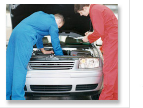 mechanics inspecting a car engine